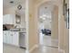 Hallway view into living area with tile floors, white kitchen cabinets and stainless steel appliances at 3938 Calabria Ave, Davenport, FL 33897