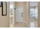 Well-lit hallway with tile flooring leading to the front door at 3938 Calabria Ave, Davenport, FL 33897