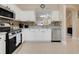 Open kitchen design featuring stainless steel appliances, mosaic backsplash, and tile floor at 3938 Calabria Ave, Davenport, FL 33897