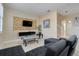 Cozy living room featuring a mounted TV with decorative gold accent wall and a comfortable sectional sofa at 3938 Calabria Ave, Davenport, FL 33897