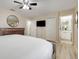 Spacious main bedroom featuring wood floors, ceiling fan, and ensuite bathroom at 3938 Calabria Ave, Davenport, FL 33897