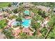 Aerial view of resort-style pool with slides and lush landscaping in this tropical community at 3938 Calabria Ave, Davenport, FL 33897
