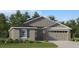 Charming single-Gathering home featuring a two-car garage, well-maintained lawn, and stylish architectural details at 3942 Bigarade Ln, Lake Alfred, FL 33850