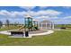 Community playground and gazebo surrounded by lush green grass and clear blue skies at 3958 Bigarade Ln, Lake Alfred, FL 33850