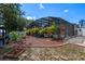Landscaped backyard features an enclosed pool area with lush tropical plants and well-kept mulch beds at 404 Obo Dr, Davenport, FL 33896