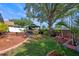 Backyard featuring an outdoor kitchen with grill and dining area, surrounded by lush landscaping and mature trees at 404 Obo Dr, Davenport, FL 33896