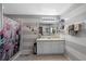 Bathroom featuring a single sink vanity, striped walls, and a walk-in shower with a decorative curtain at 404 Obo Dr, Davenport, FL 33896