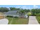 Aerial view of a well-maintained home featuring manicured lawns and mature trees at 404 Obo Dr, Davenport, FL 33896