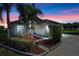Charming home with lush landscaping, palm trees, and a paver walkway leading to the front door at 404 Obo Dr, Davenport, FL 33896