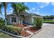 Charming home with lush landscaping, palm trees, and a paver walkway leading to the front door at 404 Obo Dr, Davenport, FL 33896