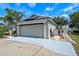 Spacious two-car garage with solar panels, an extra-long driveway and side yard access at 404 Obo Dr, Davenport, FL 33896