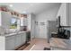 Bright eat-in kitchen featuring white cabinets, neutral counters and floors, stainless appliances and a window overlooking the yard at 404 Obo Dr, Davenport, FL 33896