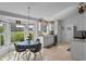 Sunlit eat-in kitchen with updated white cabinets, neutral counters and floors, and a bay window with views of the garden at 404 Obo Dr, Davenport, FL 33896