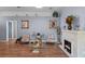 Comfortable living room with a fireplace, hardwood floors, and stylish decor at 404 Obo Dr, Davenport, FL 33896