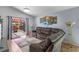 Living room with hardwood floors and sliding glass doors leading to a covered patio at 404 Obo Dr, Davenport, FL 33896