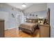 Main bedroom featuring wood floors, high ceilings, and a ensuite bathroom at 404 Obo Dr, Davenport, FL 33896