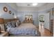 Bright main bedroom featuring wood floors, dresser and view to dining area at 404 Obo Dr, Davenport, FL 33896