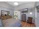 Spacious main bedroom featuring wood floors, dresser and view to the main bathroom at 404 Obo Dr, Davenport, FL 33896