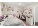 Charming bedroom with pink accents, a bed with star patterned comforter, and a desk with chair at 4111 Dublin St, Orlando, FL 32812