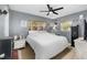 Comfortable bedroom with neutral gray walls, white comforter, and wood-look blinds for privacy at 4111 Dublin St, Orlando, FL 32812