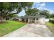 Charming single-story home featuring a long driveway, front lawn, and a covered carport at 4111 Dublin St, Orlando, FL 32812