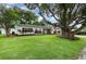 Charming single-story home featuring a lush green lawn and mature tree offering shade and curb appeal at 4111 Dublin St, Orlando, FL 32812