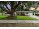 Charming single-story home featuring a lush green lawn and mature tree offering shade and curb appeal at 4111 Dublin St, Orlando, FL 32812