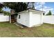 A detached garage features a convenient outdoor brick fireplace and ample storage at 4111 Dublin St, Orlando, FL 32812