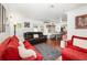 Open-concept living room featuring wood floors, comfortable seating, and dining area at 4111 Dublin St, Orlando, FL 32812