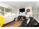 Cozy living room features a comfortable black leather sofa, and an Alabama college football theme at 4111 Dublin St, Orlando, FL 32812