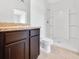 Modern bathroom features a granite vanity, tile floor, and a pristine white shower at 437 Caribbean Ct, Kissimmee, FL 34759