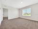 Bedroom featuring neutral carpet, a large window, and a closet for ample storage at 437 Caribbean Ct, Kissimmee, FL 34759