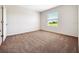 Bright bedroom with neutral carpet, white walls, and a window with a pleasant outdoor view at 437 Caribbean Ct, Kissimmee, FL 34759