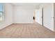 Light-filled bedroom with neutral carpet and white walls, leading into an open doorway at 437 Caribbean Ct, Kissimmee, FL 34759