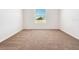 Carpeted bedroom featuring a window providing natural light and a view of the outdoors at 437 Caribbean Ct, Kissimmee, FL 34759