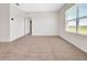 Bright bedroom with neutral carpet and a large window with blinds for natural light and privacy at 437 Caribbean Ct, Kissimmee, FL 34759