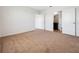 Bedroom with neutral carpet leading to a bathroom with a granite vanity and tile flooring at 437 Caribbean Ct, Kissimmee, FL 34759