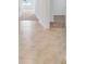 Hallway with tile flooring transitions into carpeted bedrooms in a well-lit home at 437 Caribbean Ct, Kissimmee, FL 34759