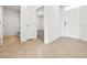 Hallway with tile flooring leading to a bathroom and a bedroom with carpet at 437 Caribbean Ct, Kissimmee, FL 34759