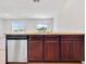 Kitchen island with breakfast bar seating, stainless steel dishwasher, and ample cabinet space at 437 Caribbean Ct, Kissimmee, FL 34759