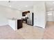 Modern kitchen with stainless steel appliances, island, dark cabinets, and easy access to the entry hall at 437 Caribbean Ct, Kissimmee, FL 34759
