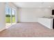 Open-concept living room with slider to the backyard, and kitchen with island and sink at 437 Caribbean Ct, Kissimmee, FL 34759