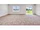 Spacious living room featuring large window and slider to backyard with view of the outdoors at 437 Caribbean Ct, Kissimmee, FL 34759