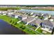 Aerial view showcases a community nestled by a lake, complete with manicured lawns and houses at 4444 Quartz Ct, Lakeland, FL 33811