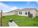 The backyard includes a covered patio and a grill, with a fence that provides privacy at 4444 Quartz Ct, Lakeland, FL 33811