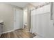 Clean bathroom featuring a shower with curtain and wood-look flooring and modern fixtures at 4444 Quartz Ct, Lakeland, FL 33811