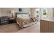 Inviting bedroom with soft lighting, carpet floors, and a cozy bed with a decorative throw at 4444 Quartz Ct, Lakeland, FL 33811
