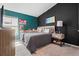 Cozy bedroom featuring a teal accent wall, soft lighting, and stylish decor at 4444 Quartz Ct, Lakeland, FL 33811