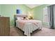 Green bedroom with plush carpet, soft bedding and a gray headboard with a side dresser at 4444 Quartz Ct, Lakeland, FL 33811