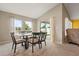Bright dining room featuring a table with six chairs, sliding glass door and a neutral color scheme at 4444 Quartz Ct, Lakeland, FL 33811
